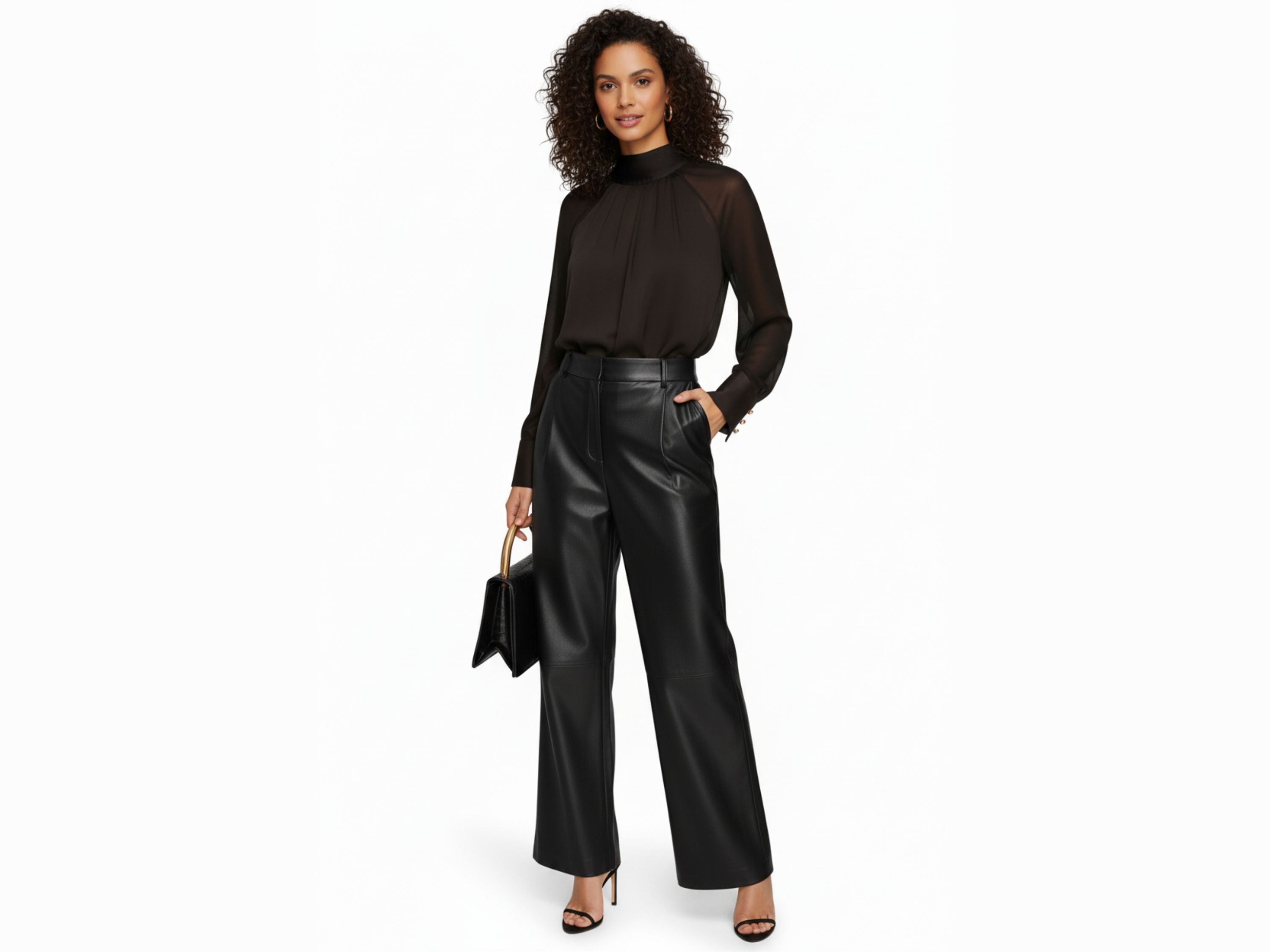Woman wearing a black blouse and leather pants on a white background
