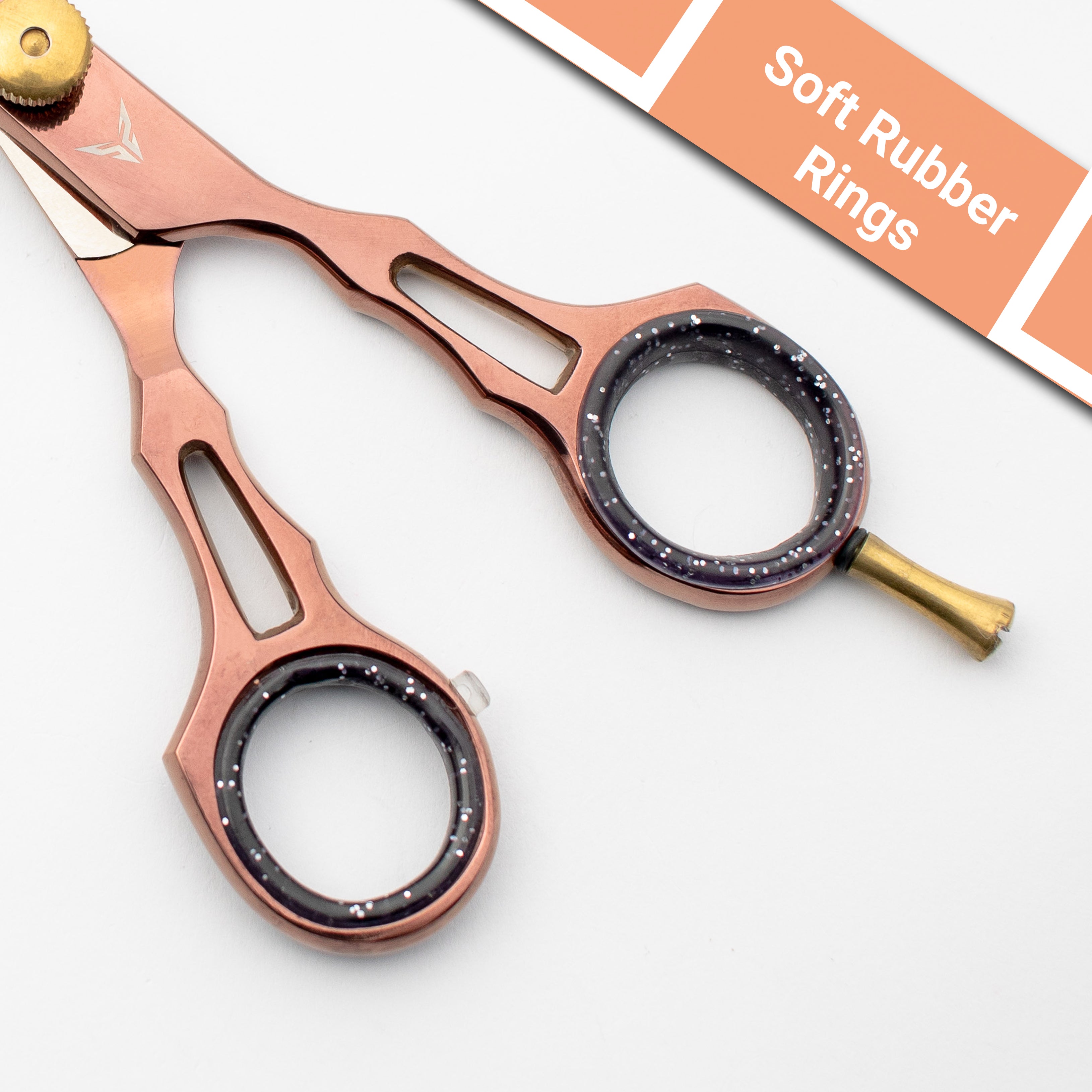 Rose gold scissors with black rubber rings on a white background
