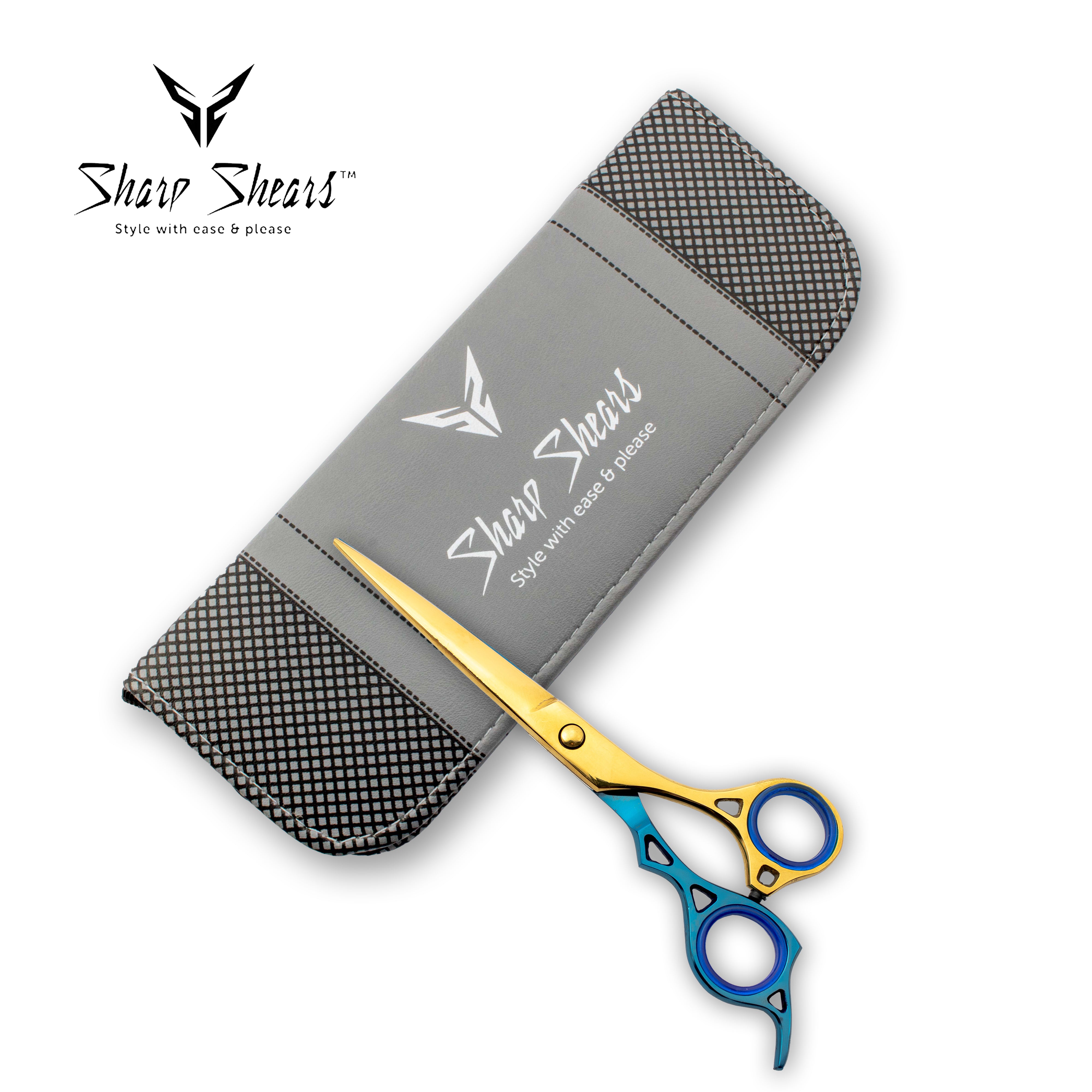 Shear Shears scissors with gold and blue handles and a gray case on a white background.